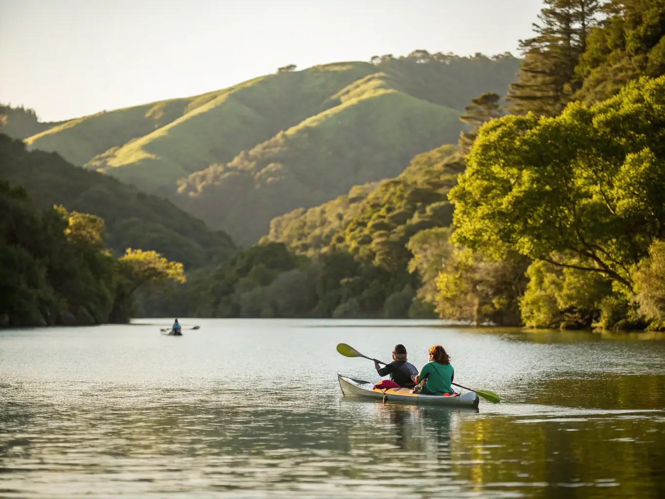 An action shot of kayakers paddling through calm waters, emphasizing the physical activity and scenic beauty. This image represents the kayaking activities available at CENT NAUTIQ COUARDAIS DE GOISIL.